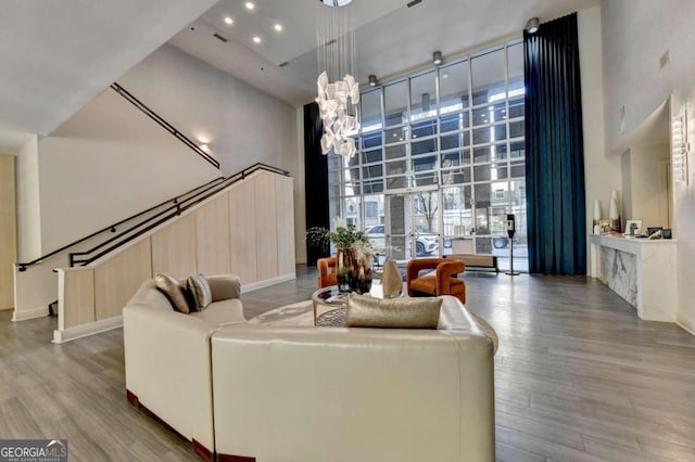 living room featuring a towering ceiling and hardwood / wood-style floors