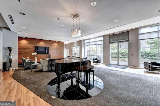 rec room featuring hardwood / wood-style floors and wooden walls