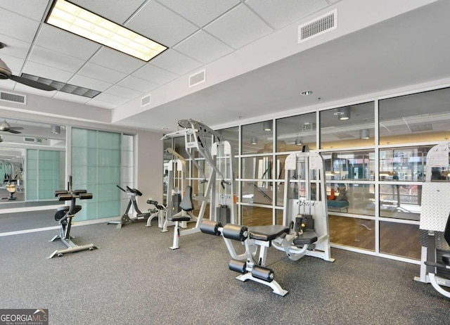 exercise room with a paneled ceiling