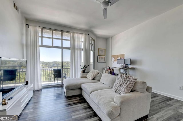 living room with ceiling fan and dark hardwood / wood-style flooring