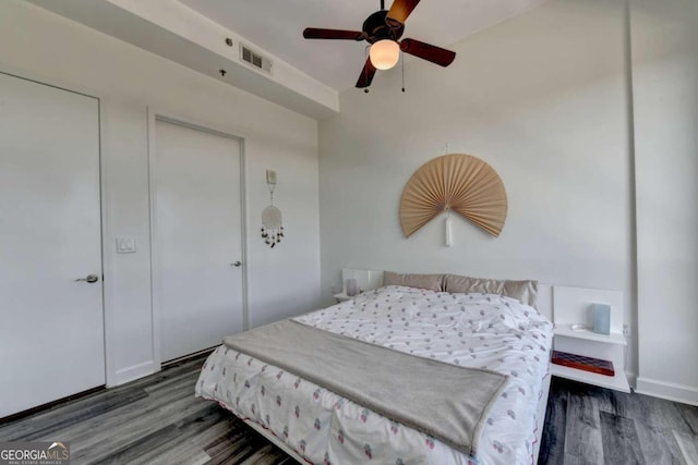 bedroom with ceiling fan and dark hardwood / wood-style flooring