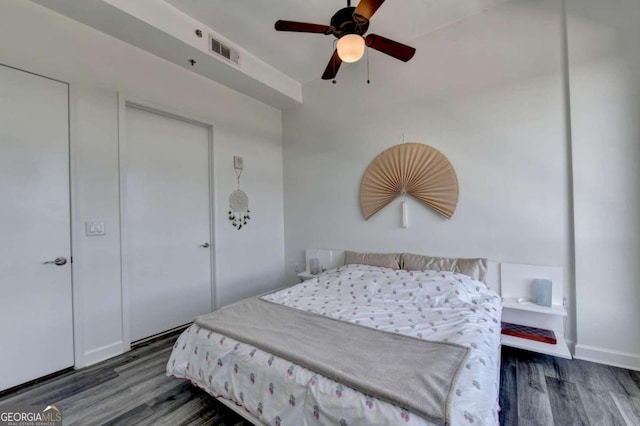 bedroom with ceiling fan and dark hardwood / wood-style flooring