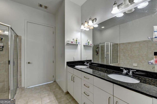 bathroom with walk in shower, tile patterned floors, and vanity