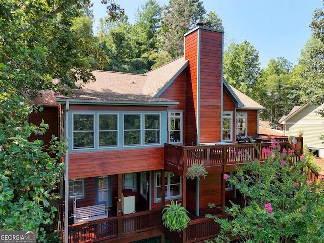 rear view of property with a wooden deck