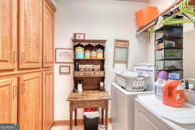 washroom with cabinets and washer and dryer