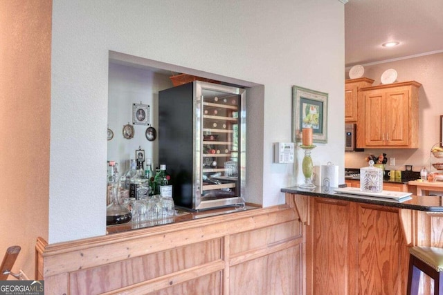 bar featuring crown molding, light brown cabinets, and wine cooler