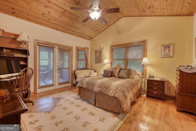 bedroom featuring access to outside, light wood-type flooring, multiple windows, and lofted ceiling