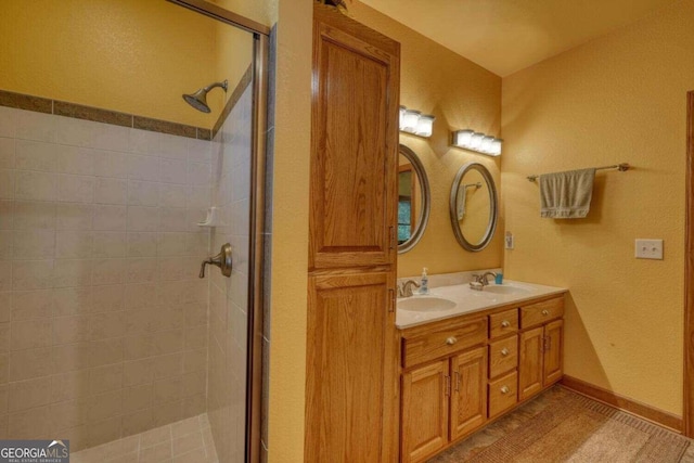 bathroom featuring tile patterned floors, vanity, and a shower with shower door