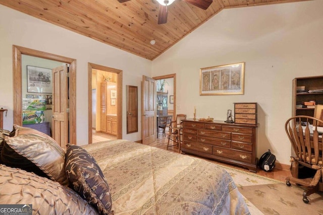 bedroom featuring light wood-type flooring, ceiling fan, connected bathroom, wooden ceiling, and vaulted ceiling