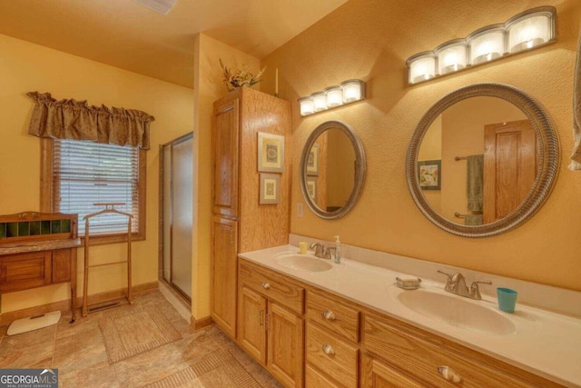 bathroom featuring tile patterned flooring, vanity, and a shower with shower door