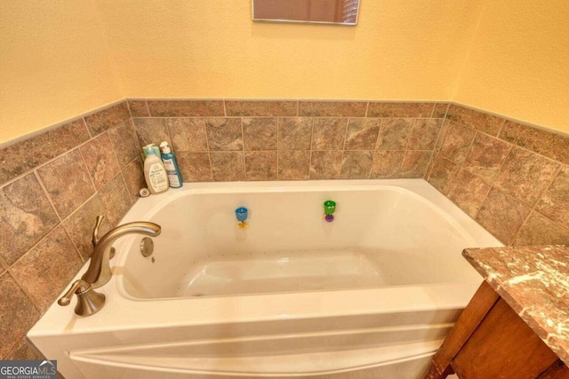 bathroom featuring vanity and a bathing tub