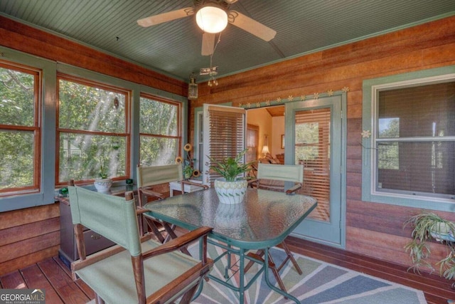 sunroom / solarium featuring ceiling fan