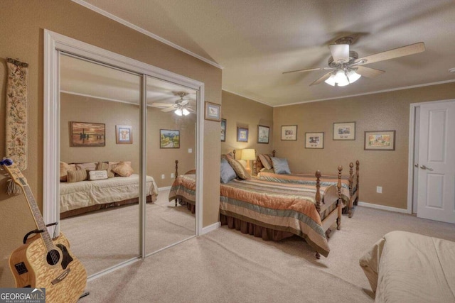 carpeted bedroom with ceiling fan, a textured ceiling, a closet, and crown molding