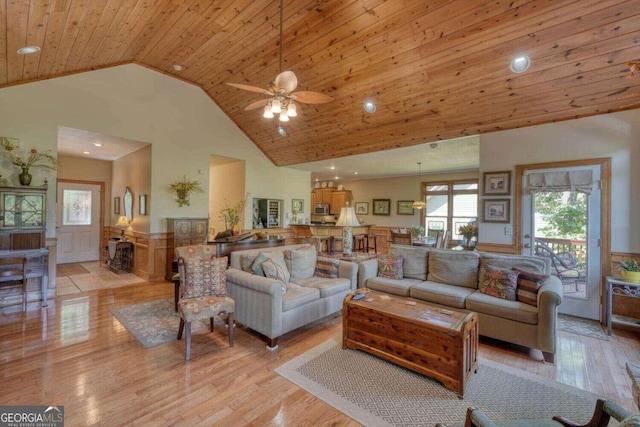 living room with wooden ceiling, light hardwood / wood-style floors, high vaulted ceiling, and ceiling fan