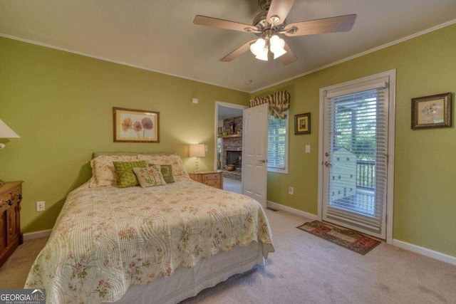 bedroom featuring ceiling fan, light carpet, a stone fireplace, access to outside, and ornamental molding