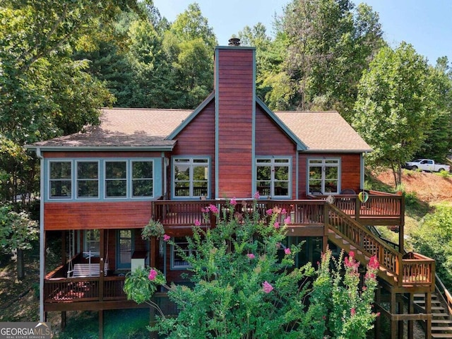 rear view of house with a wooden deck