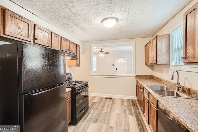 kitchen with ceiling fan, sink, light hardwood / wood-style flooring, a textured ceiling, and black appliances