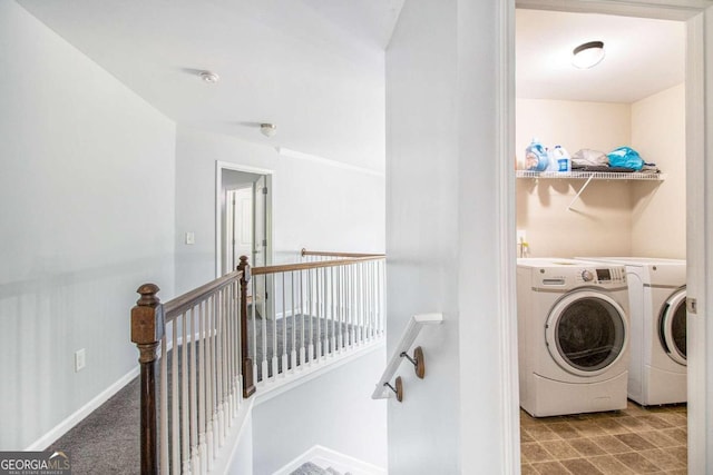 clothes washing area with washing machine and clothes dryer