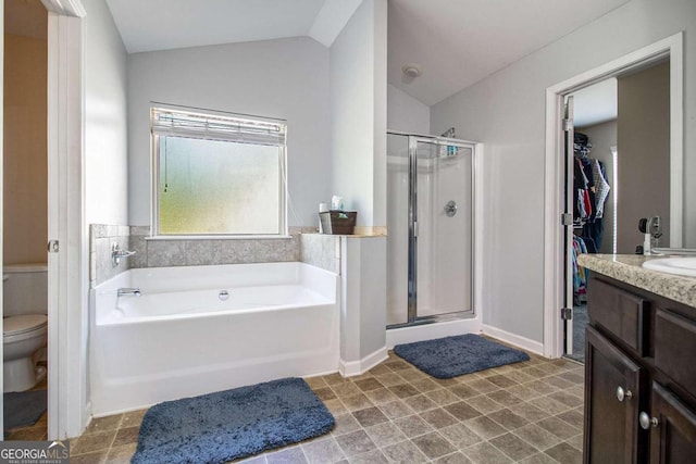 full bathroom with separate shower and tub, vaulted ceiling, vanity, and toilet