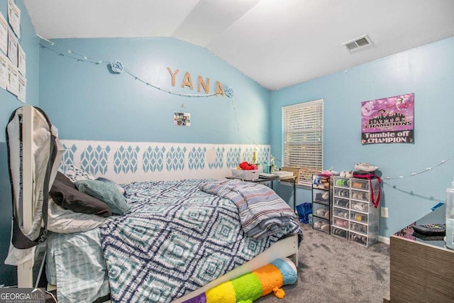 bedroom featuring lofted ceiling and carpet flooring