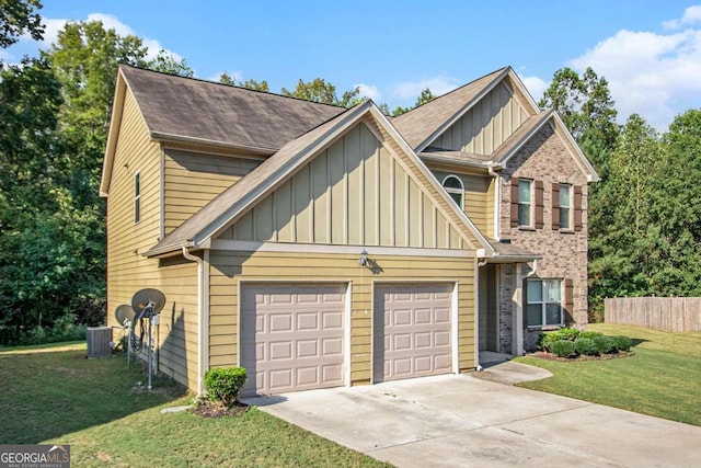 view of front of property with a front yard, a garage, and central AC