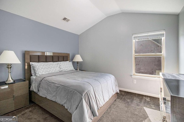 bedroom with vaulted ceiling and carpet flooring