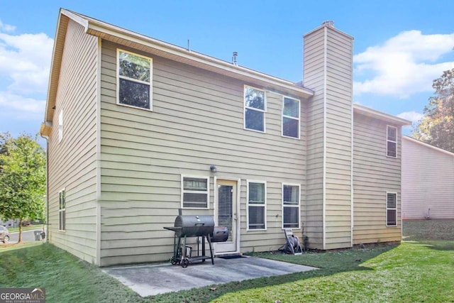 rear view of property featuring a yard and a patio area