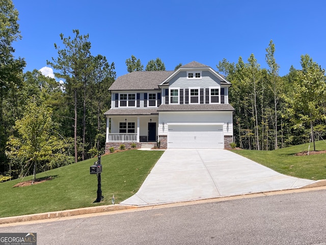 view of front of home featuring a porch, a garage, and a front lawn