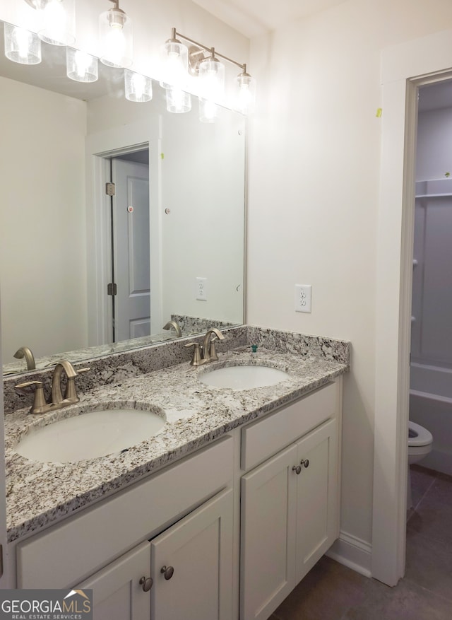 bathroom with tile patterned flooring, vanity, toilet, and a bathing tub