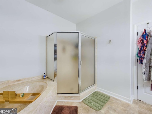 bathroom featuring plus walk in shower and tile patterned floors