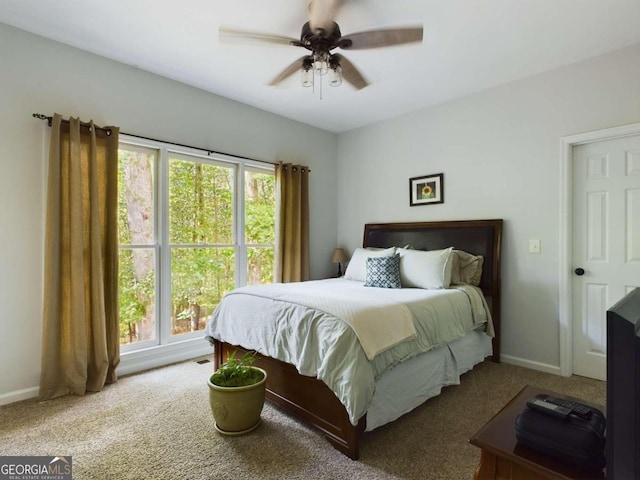 bedroom featuring ceiling fan and carpet