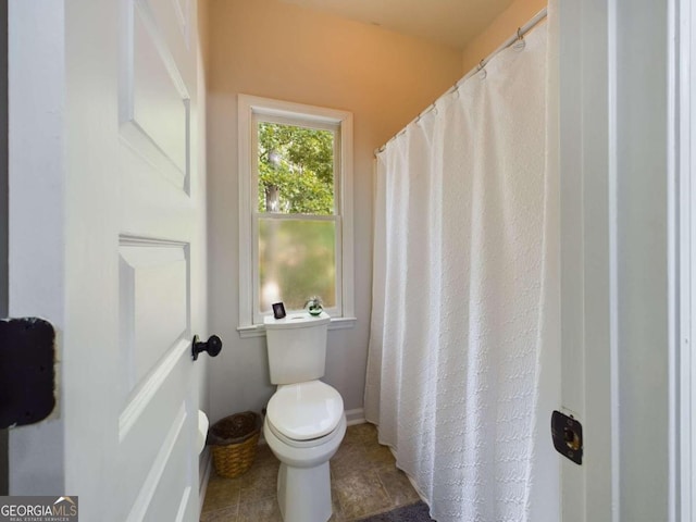 bathroom with tile patterned floors and toilet