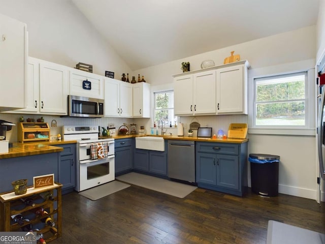 kitchen featuring blue cabinets, white cabinets, and appliances with stainless steel finishes