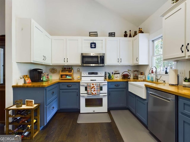 kitchen featuring blue cabinets, dark hardwood / wood-style flooring, wood counters, stainless steel appliances, and white cabinets