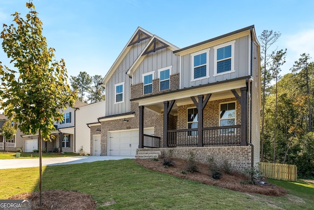 craftsman house with a garage, a front lawn, and covered porch