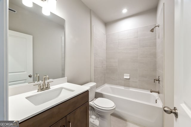 full bathroom with vanity, tiled shower / bath combo, and toilet