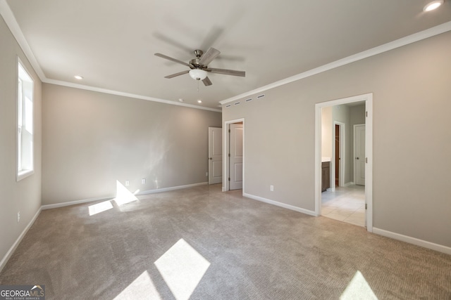 unfurnished bedroom featuring light carpet, connected bathroom, ornamental molding, and ceiling fan