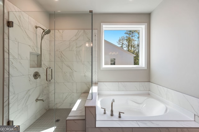 bathroom featuring separate shower and tub