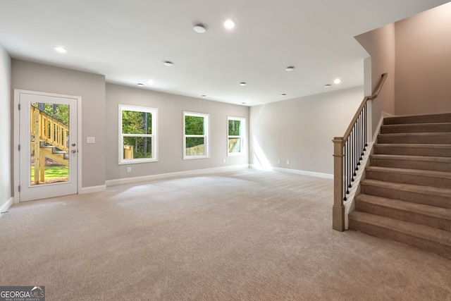 unfurnished living room with light colored carpet