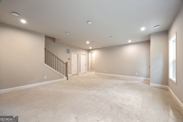 empty room with plenty of natural light and light colored carpet