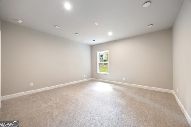 empty room featuring light colored carpet