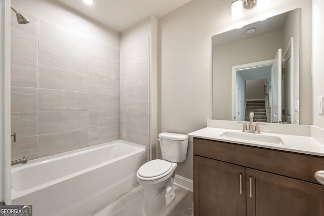 full bathroom featuring toilet, vanity, and tiled shower / bath combo