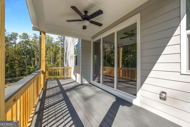 wooden deck featuring ceiling fan