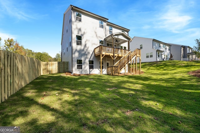 back of house with a wooden deck and a yard