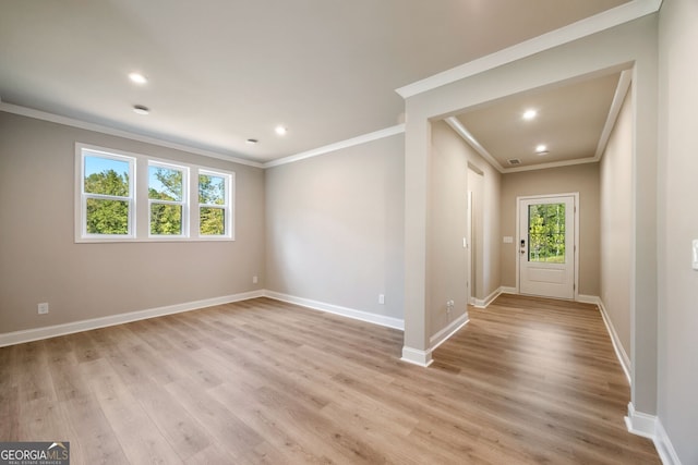 entrance foyer featuring light hardwood / wood-style flooring and crown molding