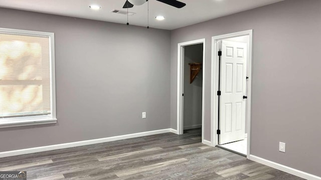 empty room with ceiling fan and hardwood / wood-style floors