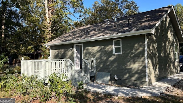 view of home's exterior with a wooden deck