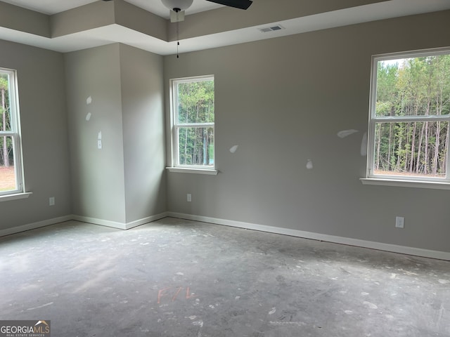 empty room featuring a wealth of natural light and ceiling fan