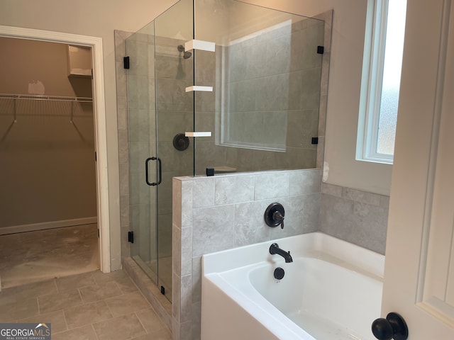 bathroom with separate shower and tub and tile patterned floors