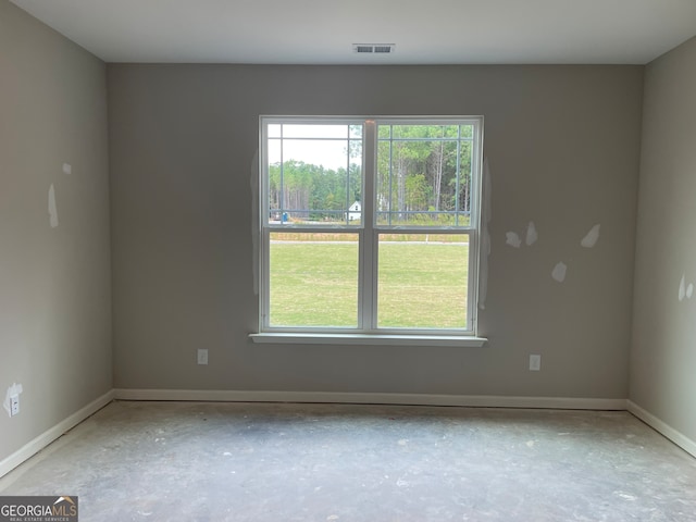 spare room with concrete flooring